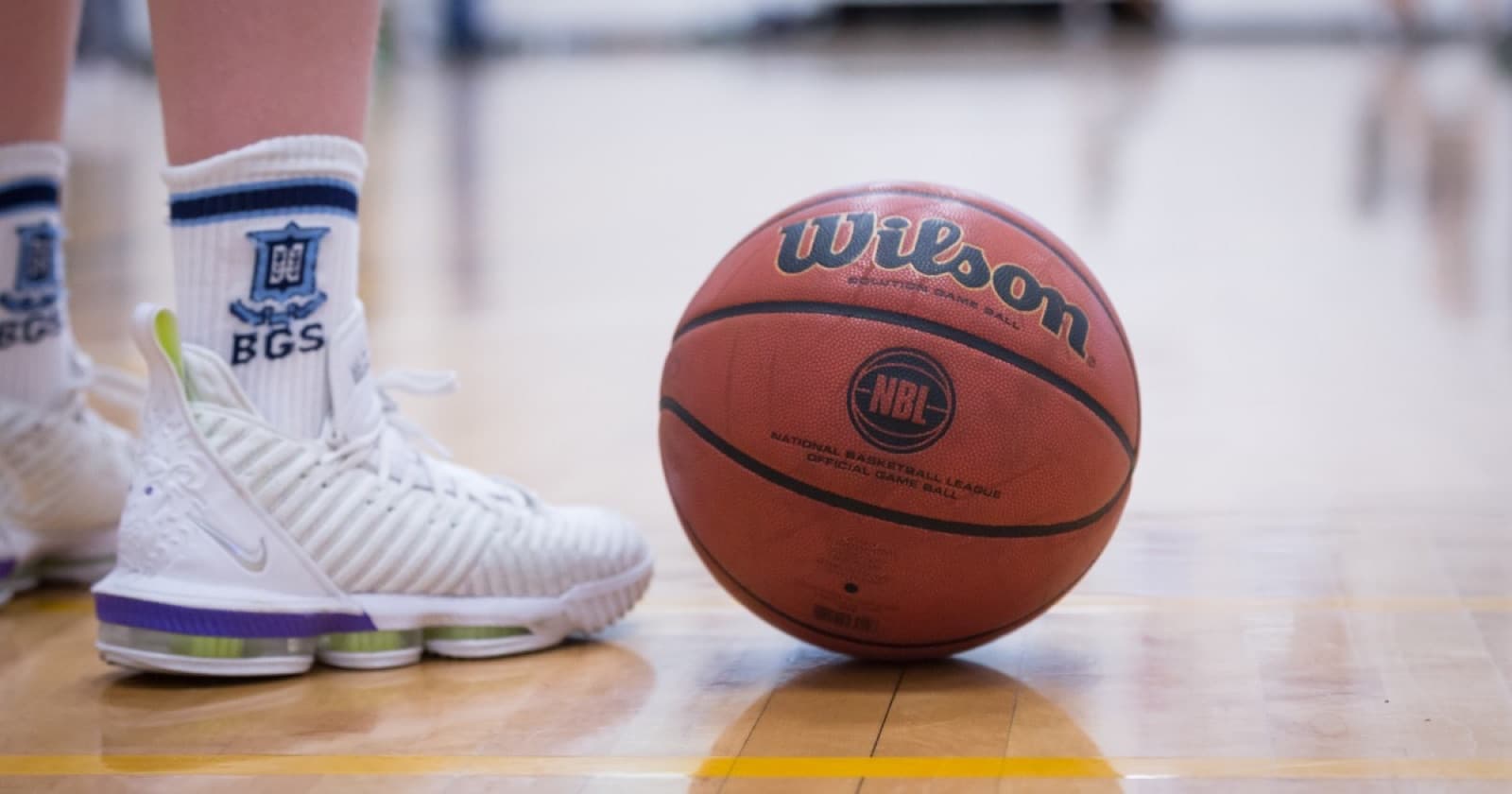 BGS basketball socks and an NBL game ball on the court at Brisbane Grammar School