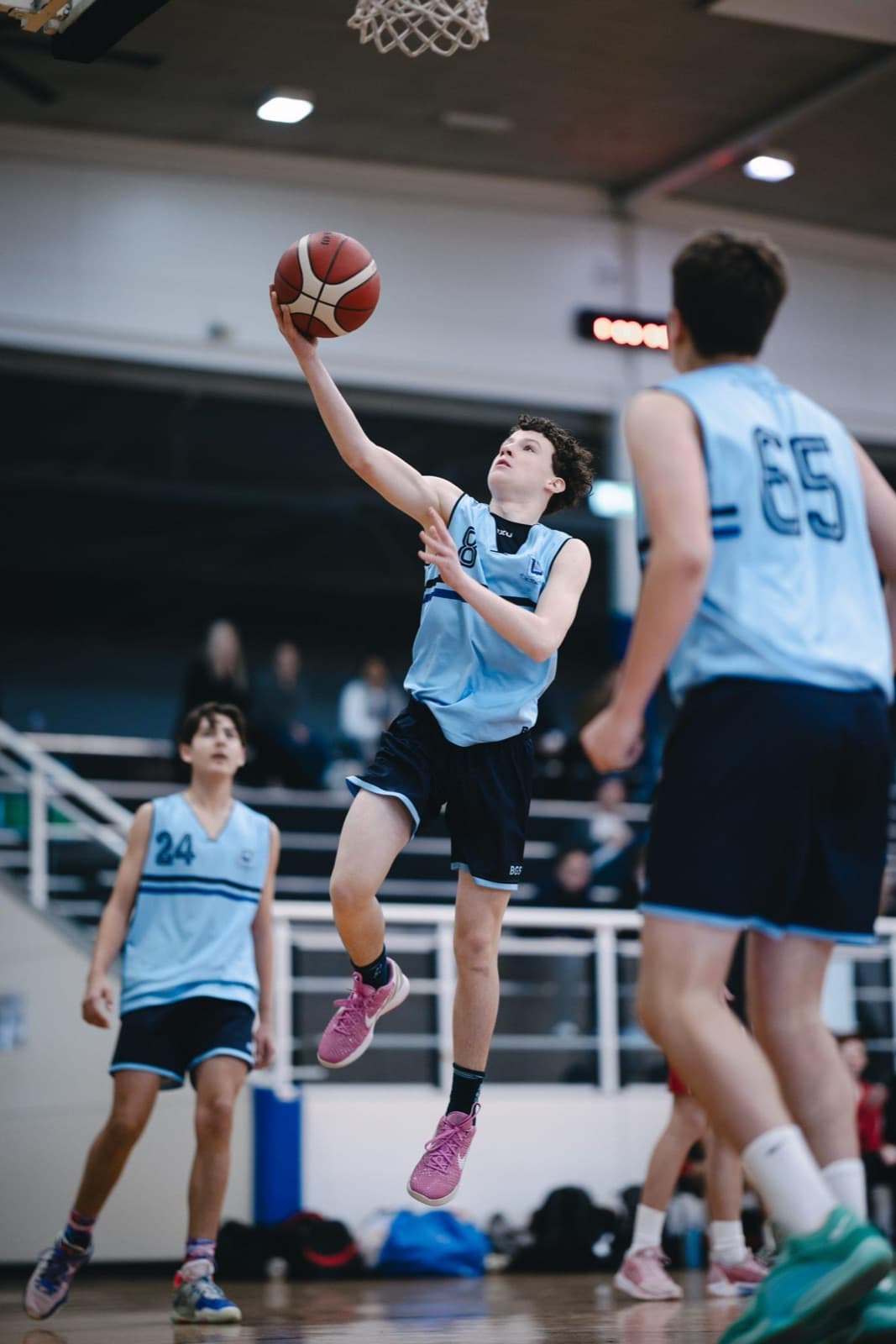 Brisbane Grammar School player going up for a layup in a school basketball game