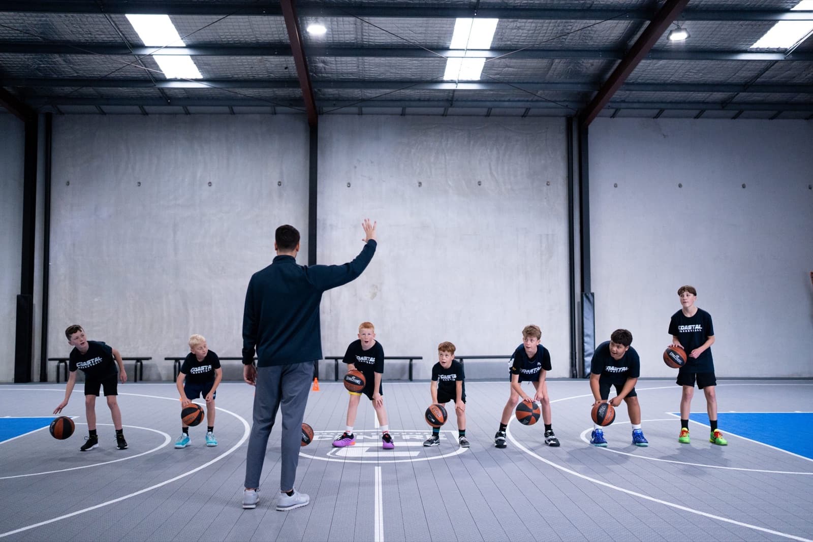 Coach running a junior ball-handling session at Coastal Basketball