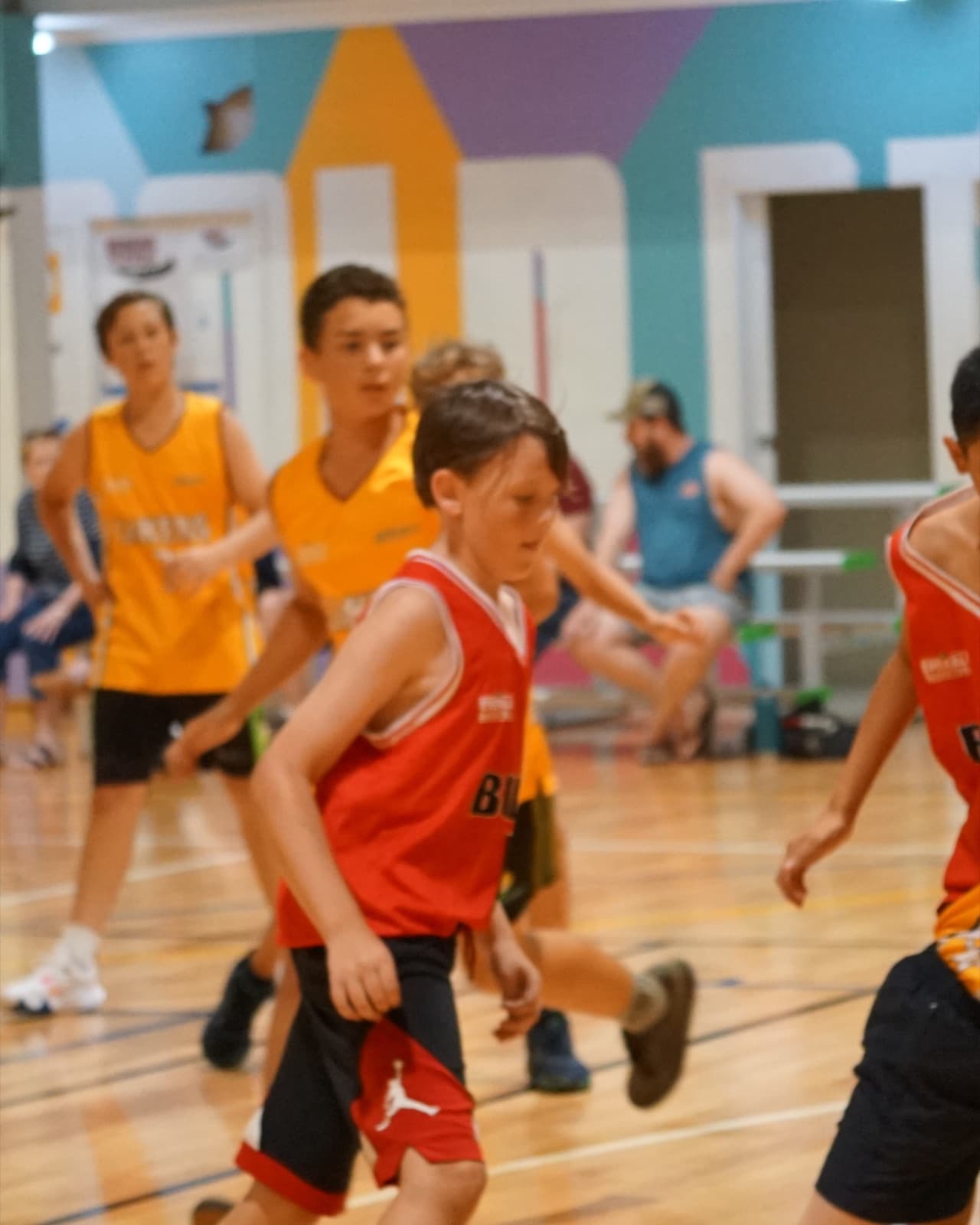 Junior club game at Emerald Basketball Association, a Bulls player driving to the basket