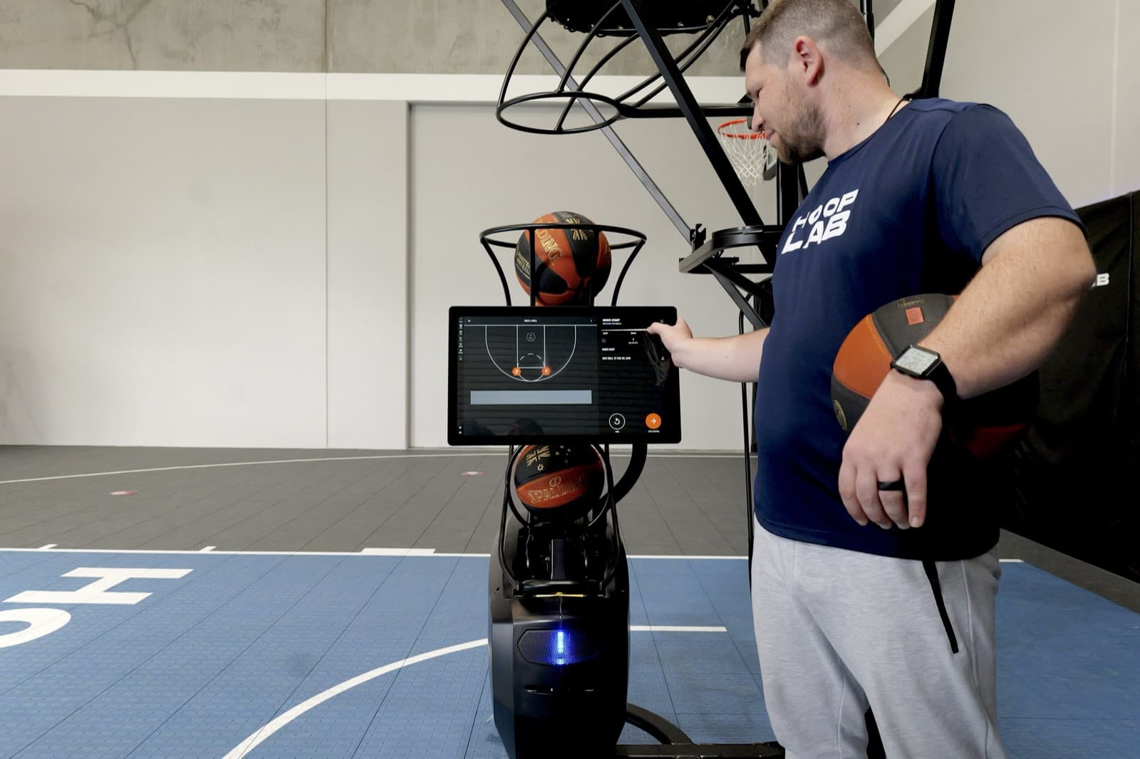 Coach programming a workout on the Dr. Dish CT+ touchscreen at HoopLab