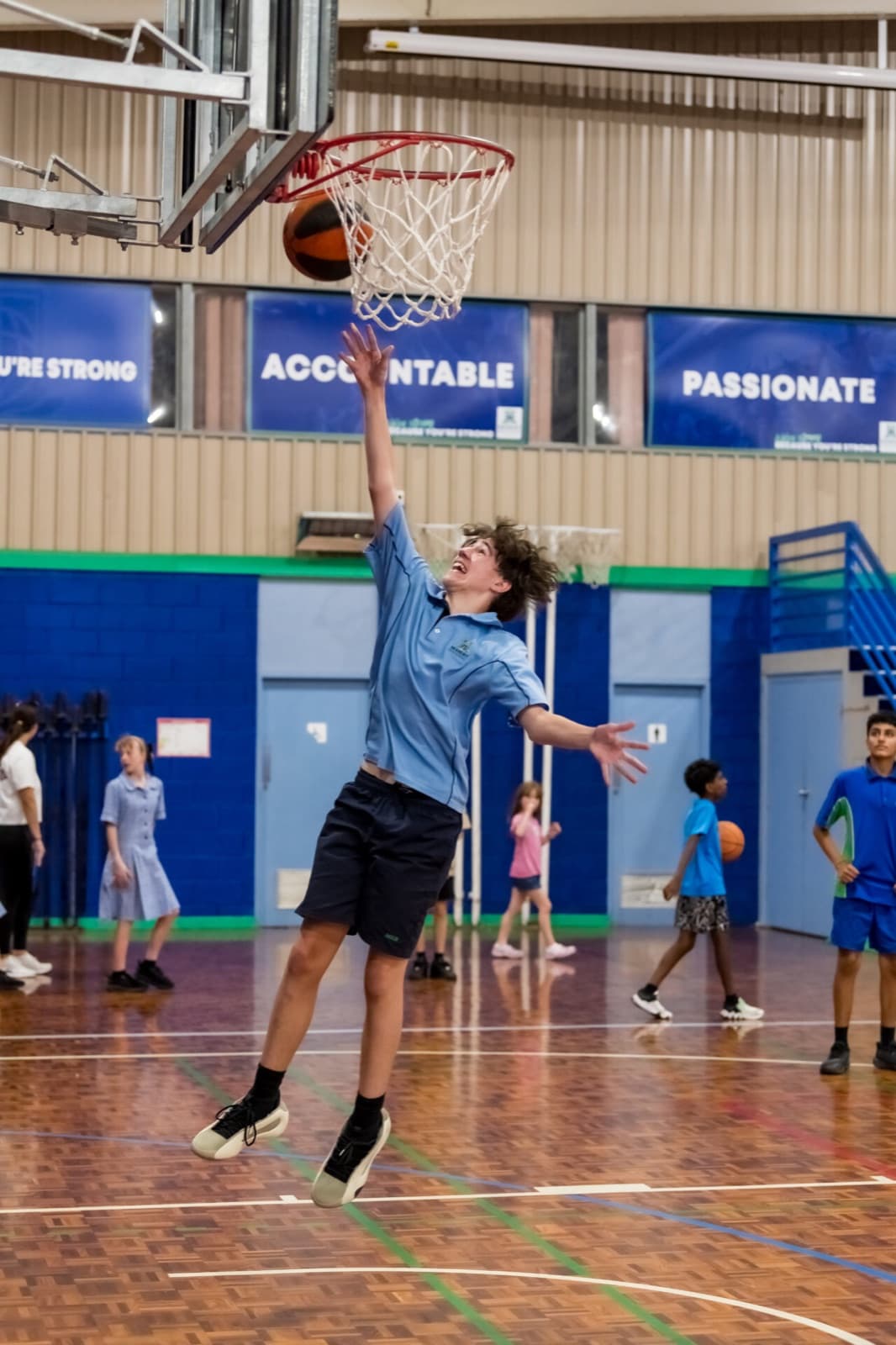 Modbury High School student going up for a layup in the school gym
