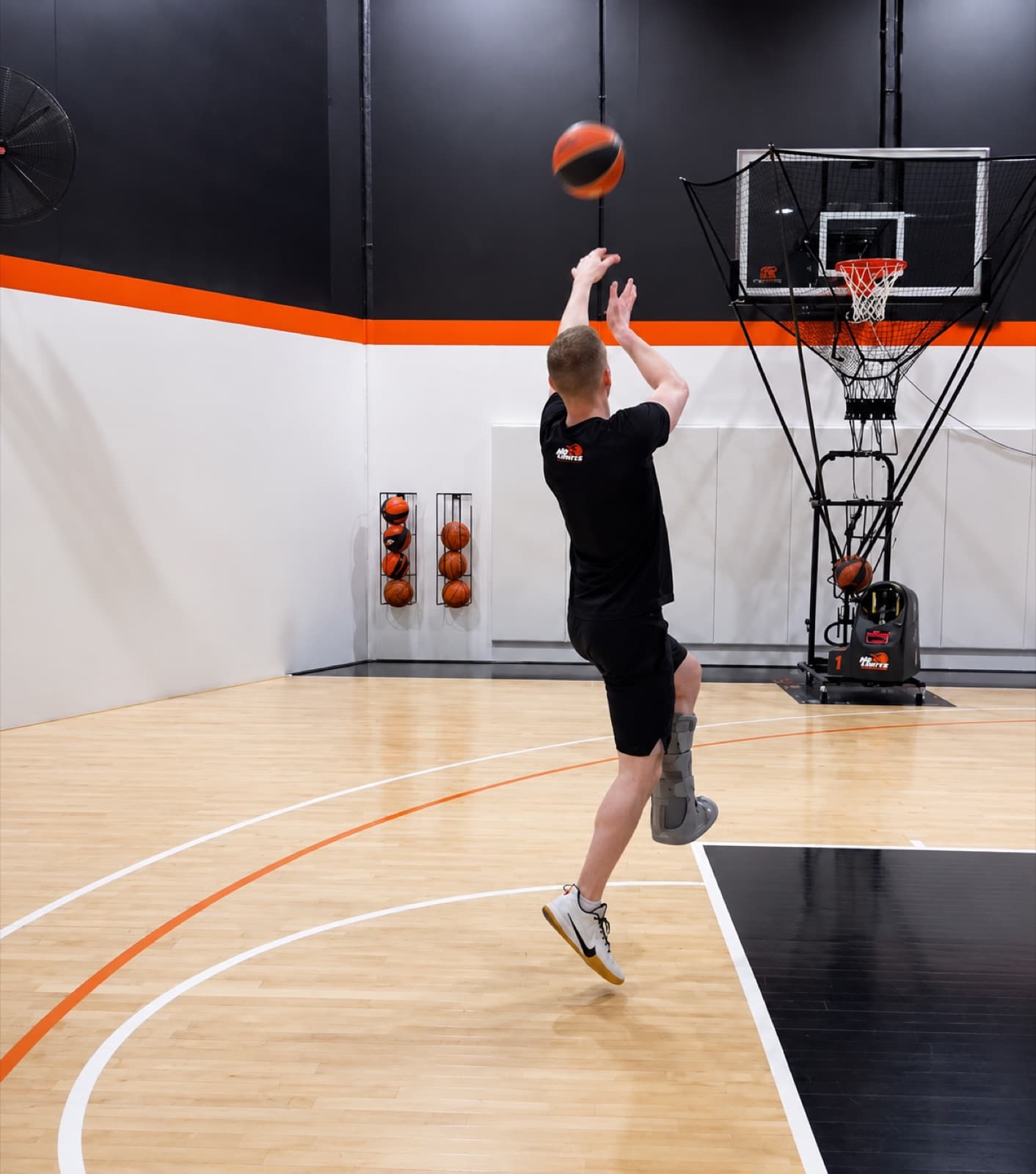 Player rising for a jump shot in front of a Dr. Dish shooting machine at The Lab, No Limits Basketball, Box Hill South
