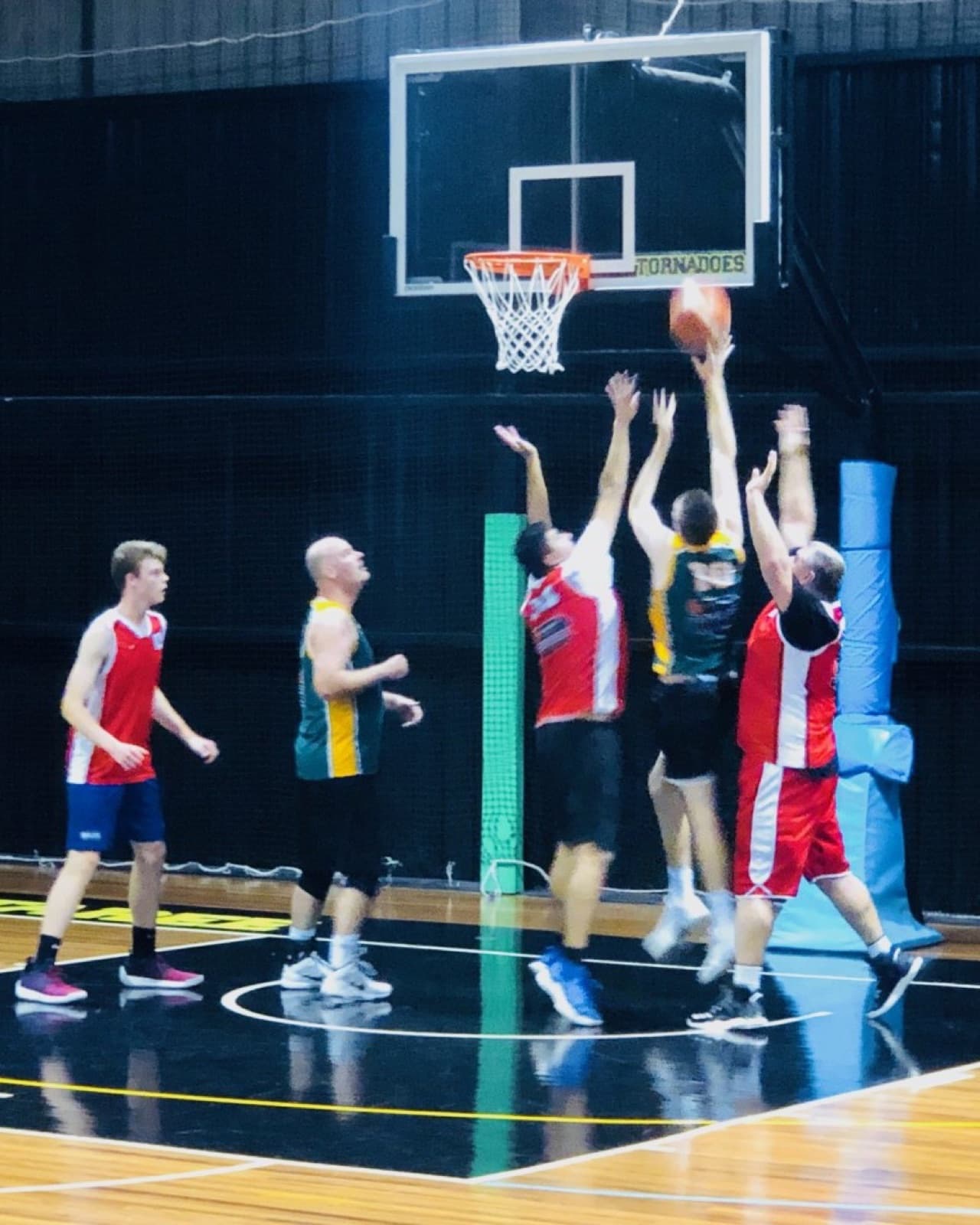 Rebound battle under the hoop in a Taree Basketball game